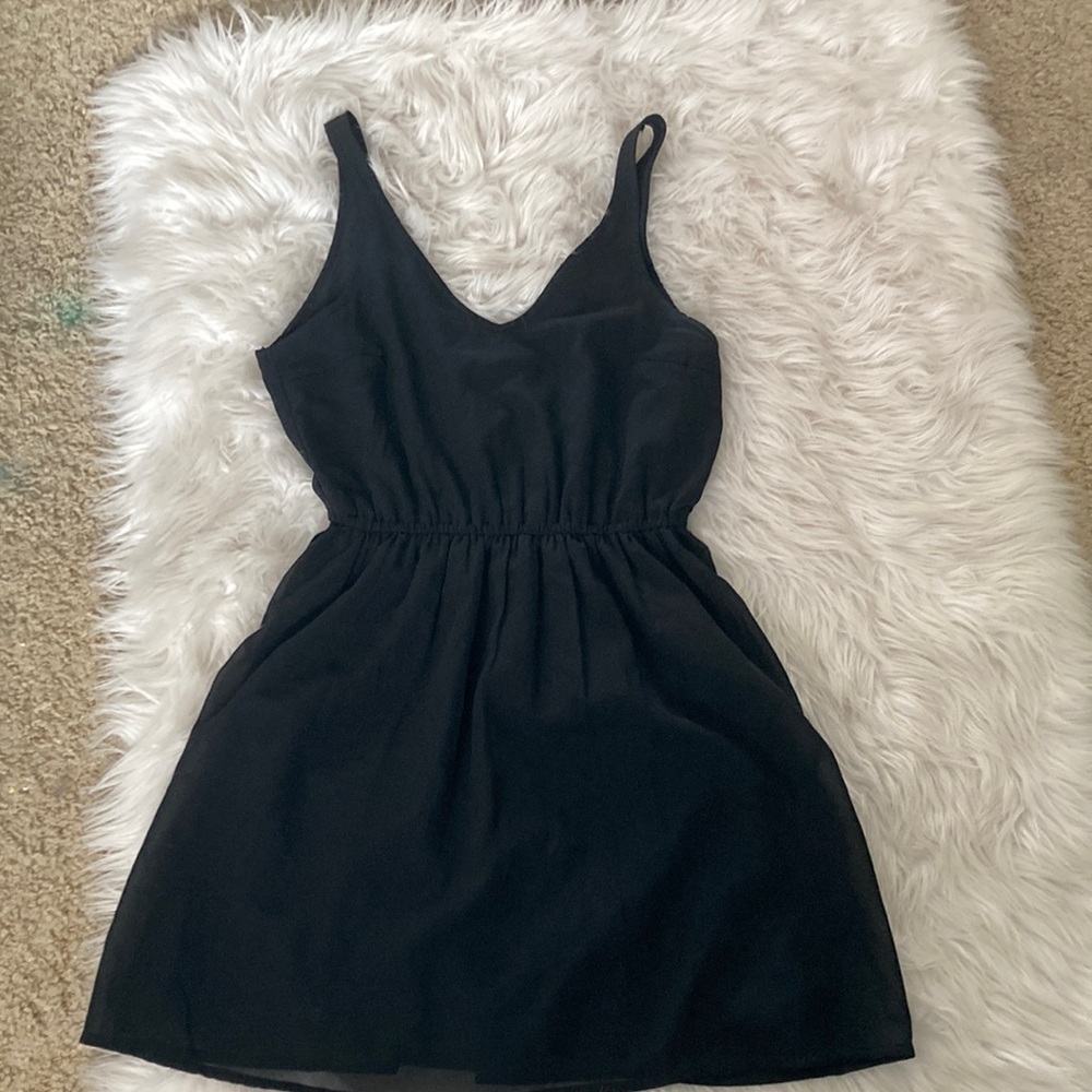 H&M, size 8. Black dress with stretchy waist band and lined.